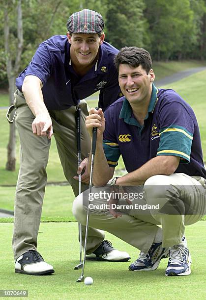 Chris Fydler who won a Gold Medal in Swimming at the 2000 Sydney Olympics gives John Eales of the Australian Wallabies Rugby Union team a few putting...