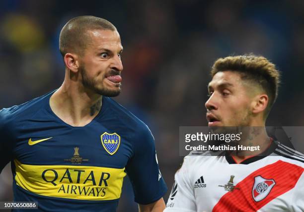 Dario Benedetto of Boca Juniors pulls a face at Gonzalo Montiel of River Plate as he celebrates after scoring his team's first goal during the second...