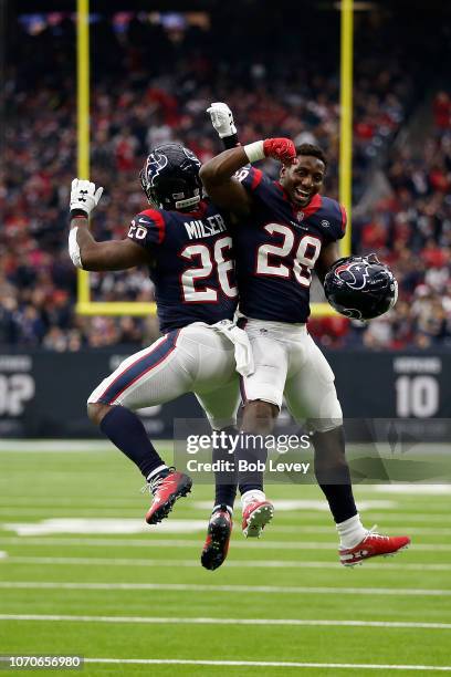 Lamar Miller and Alfred Blue of the Houston Texans celebrate a rushing touchdown against the Indianapolis Colts in the third quarter at NRG Stadium...