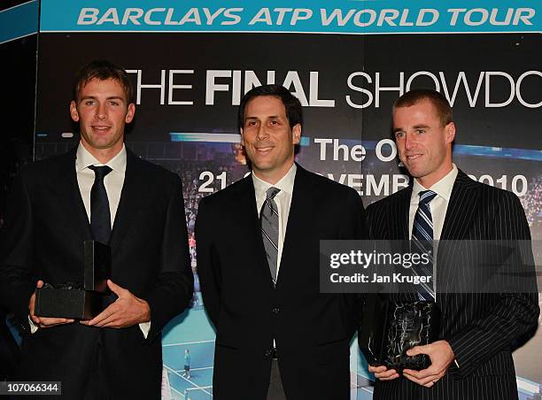 Lukasz Kubot and Oliver Marach receive their trophies from CEO of the ATP Adam Helfant during the Barclays ATP World Tour Finals - Media Day at the...