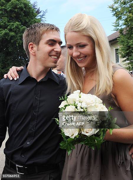 Germany's defender Philipp Lahm and his wife Claudia, former Claudia Schattenberg, chat after their marriage at the registry office in Aying,...