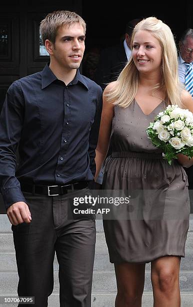 Germany's defender Philipp Lahm and his wife Claudia, former Claudia Schattenberg, leave the registry office after their marriage in Aying, southern...