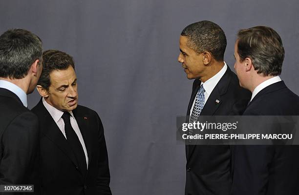 France's President Nicolas Sarkozy , US President Barack Obama and United Kingdom's Prime Minister David Cameron chat after posing for a family...