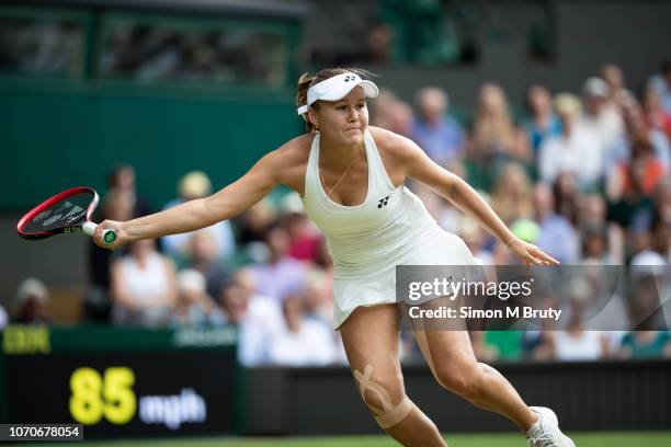 Evgeniya Rodina of Russia in action against Serena Williams of USA during The Wimbledon Lawn Tennis Championship at the All England Lawn Tennis and...