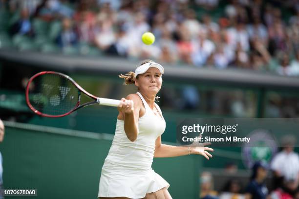 Evgeniya Rodina of Russia in action against Serena Williams of USA during The Wimbledon Lawn Tennis Championship at the All England Lawn Tennis and...