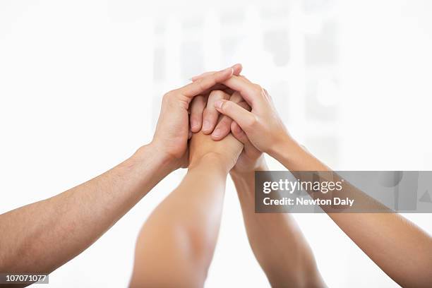 hands raised together - newfamily stock pictures, royalty-free photos & images