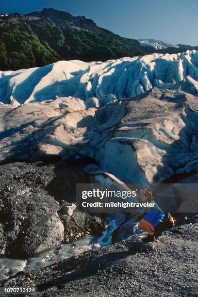 woman hiker explores exit glacier kenai fjords national park alaska - kenai fjords national park stock pictures, royalty-free photos & images