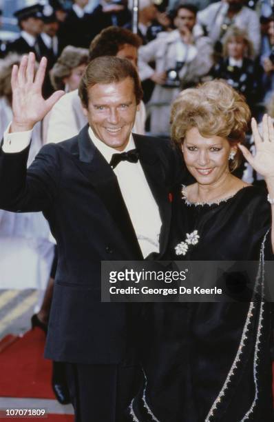 English actor Roger Moore with his wife Luisa Mattioli at the London premiere of the James Bond film 'A View to a Kill', 12th June 1985.