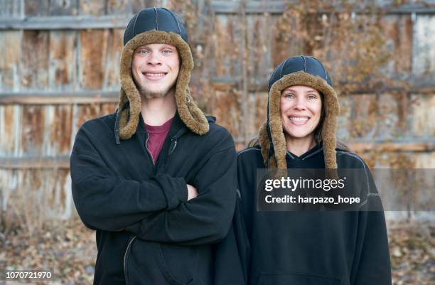 mother and son with matching hats. - imitador fotografías e imágenes de stock