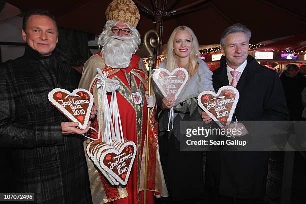 Television host Axel Bulthaupt, Father Christmas, model Franziska Knuppe and Berlin Mayor Klaus Wowereit attend the official opening of the Christmas...