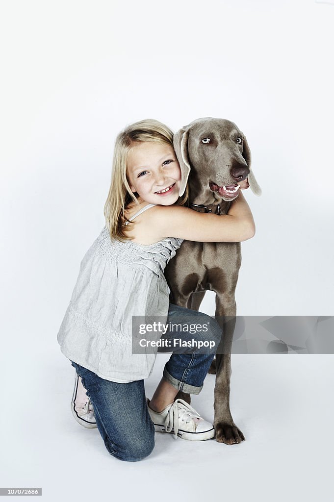 Portrait of girl hugging her pet dog