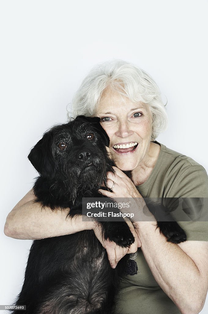 Portrait of woman hugging her pet