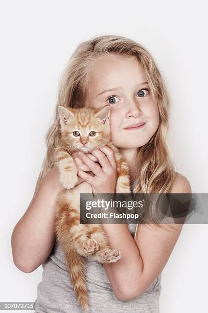 portrait of girl hugging her pet cat - young girls puss stock pictures, royalty-free photos & images