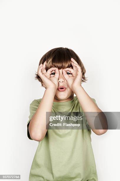 portrait of boy pulling a funny face - child white background stock pictures, royalty-free photos & images