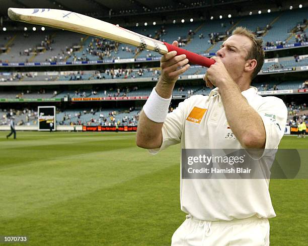 Matthew Hayden of Australia plays his bat like a trumpet in celebration, after day four of the second Test between Australia and South Africa, played...