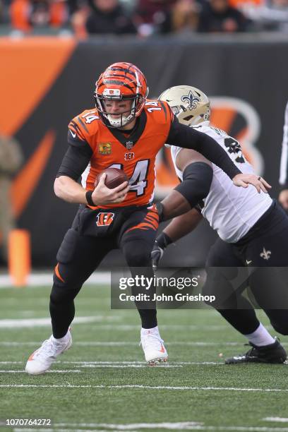 Andy Dalton of the Cincinnati Bengals runs the football upfield during the game against the New Orleans Saints at Paul Brown Stadium on November 11,...