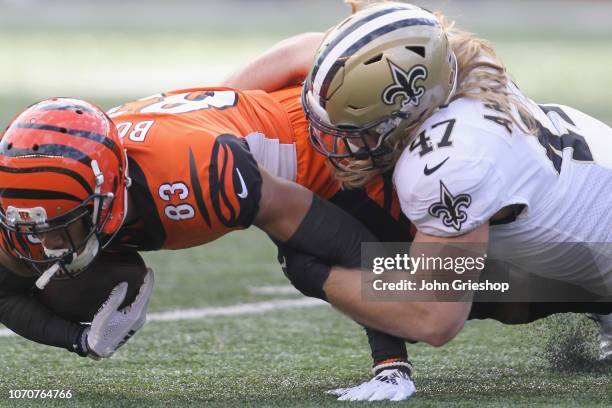 Tyler Boyd of the Cincinnati Bengals runs the football upfield against Alex Anzalone of the New Orleans Saints during their game at Paul Brown...