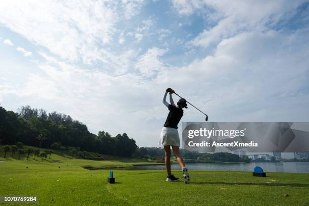 golfer making the chip - women golf stock pictures, royalty-free photos & images