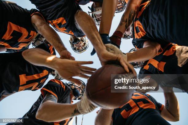 football players huddling - american football team huddle stock pictures, royalty-free photos & images