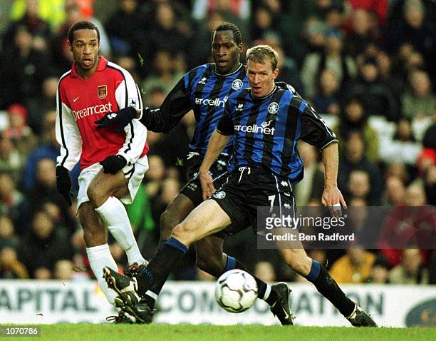 Thierry Henry of Arsenal tries ot tackle Robbie Mustoe of Middlesbrough during the FA Barclaycard Premiership match between Arsenal and Middlesbrough...