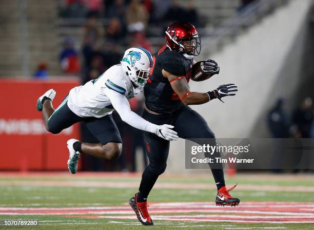 Romeo Brooker of the Houston Cougars runs after a reception defended by Marvin Moody of the Tulane Green Wave in the second half at TDECU Stadium on...