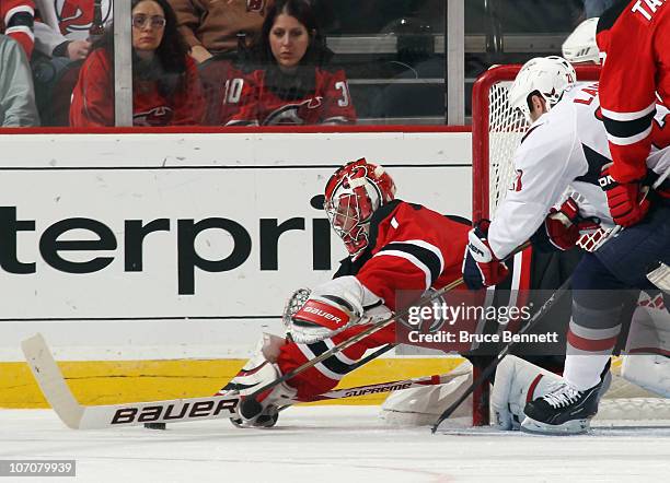 Johan Hedberg of the New Jersey Devils makes the save in route to a 5-0 shut out of the Washington Capitals at the Prudential Center on November 22,...