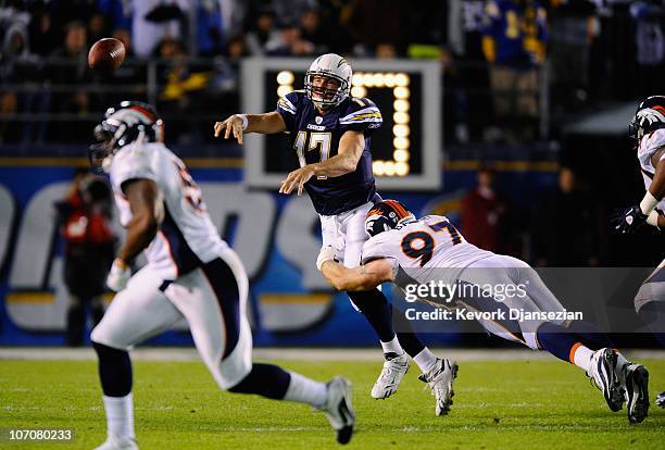 Quarterback Philip Rivers of the San Diego Chargers throws an incomplete pass under pressure from Justin Bannan of the Denver Broncos at Qualcomm...