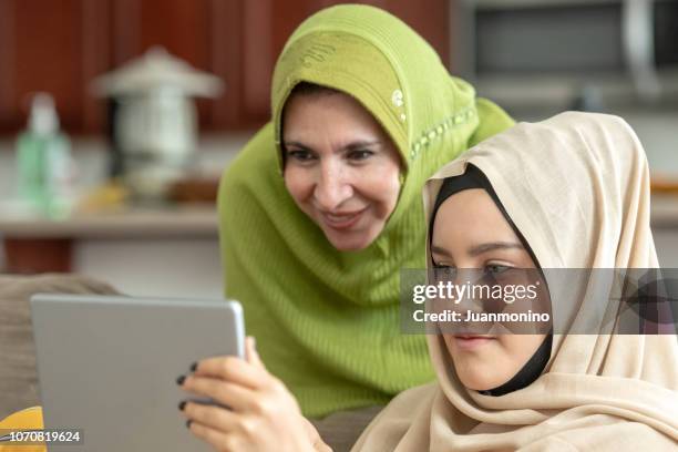 muslim mature woman posing with her young daughter - moroccan girl stock pictures, royalty-free photos & images