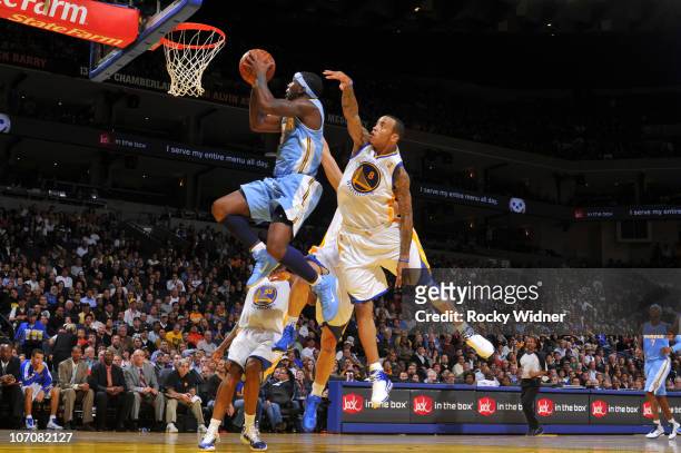 Ty Lawson of the Denver Nuggets drives the ball against Monta Ellis of the Golden State Warriors on November 22, 2010 at Oracle Arena in Oakland,...