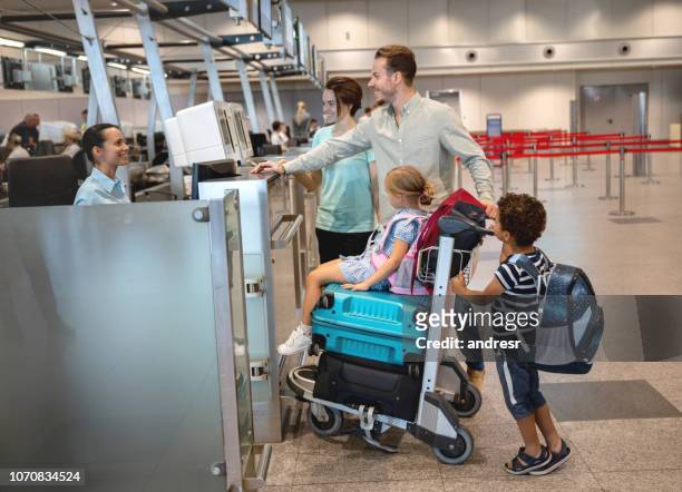 happy couple traveling with kids and doing the check-in - russia travel stock pictures, royalty-free photos & images