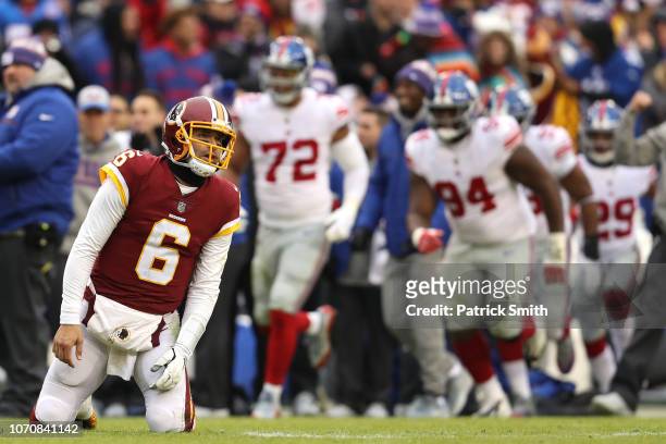 Quarterback Mark Sanchez of the Washington Redskins reacts after an interception in the second quarter against the New York Giants at FedExField on...