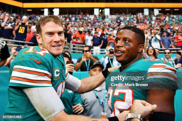 Ryan Tannehill and Kenyan Drake of the Miami Dolphins celebrate their 34 to 33 win over the the New England Patriots at Hard Rock Stadium on December...