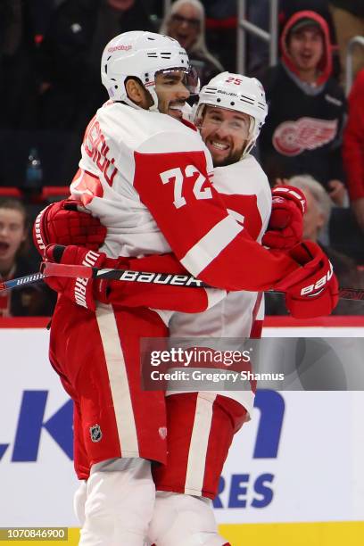 Andreas Athanasiou of the Detroit Red Wings celebrates his game winning overtime goal with Mike Green to defeat the Boston Bruins 3-2 at Little...