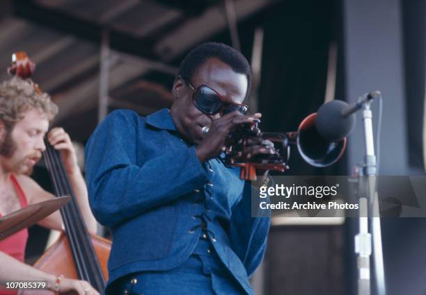 American trumpeter and composer Miles Davis performing at the Newport Jazz Festival at Newport, Rhode Island, 4th July 1969. On the left is Dave...
