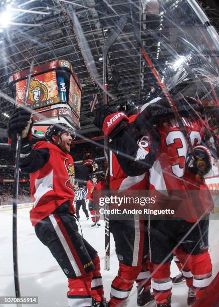 Ben Harpur and Colin White of the Ottawa Senators celebrate a first period goal by Mark Stone against the Boston Bruins at Canadian Tire Centre on...