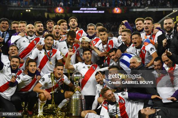 Players of River Plate celebrate with the trophy after winning the second leg match of the all-Argentine Copa Libertadores final against Boca...