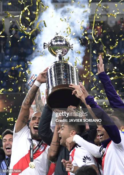 Players of River Plate celebrate with the trophy after winning the second leg match of the all-Argentine Copa Libertadores final against Boca...