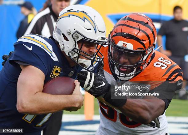 Los Angeles Chargers quarterback Philip Rivers is tackled by Cincinnati Bengals defensive end Carlos Dunlop in the first half of an NFL football game...