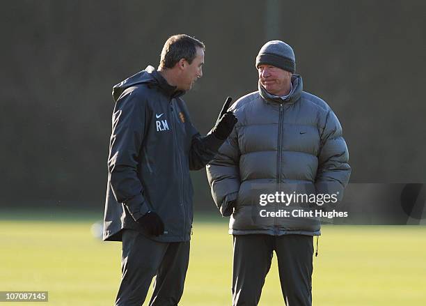 Manager, Sir Alex Ferguson and Rene Meulensteen first team coach of Manchester United watch the team during a training session ahead of their UEFA...