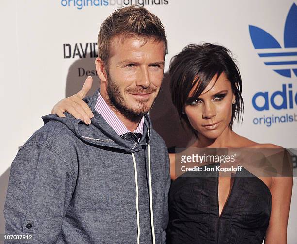Professional soccer player David Beckham and wife Victoria Beckham pose at the David Beckham And James Bond Adidas Originals on September 30, 2009 in...
