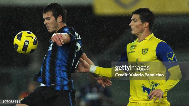 Marco Andreolli of AC Chievo Verona takes on Denis Alibec of FC Internazionale Milano during the Serie A match between AC Chievo Verona and FC...