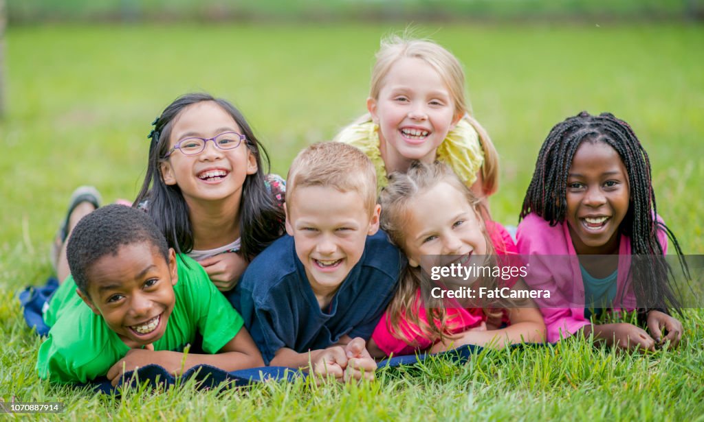 Bambini felici sdraiati nell'erba