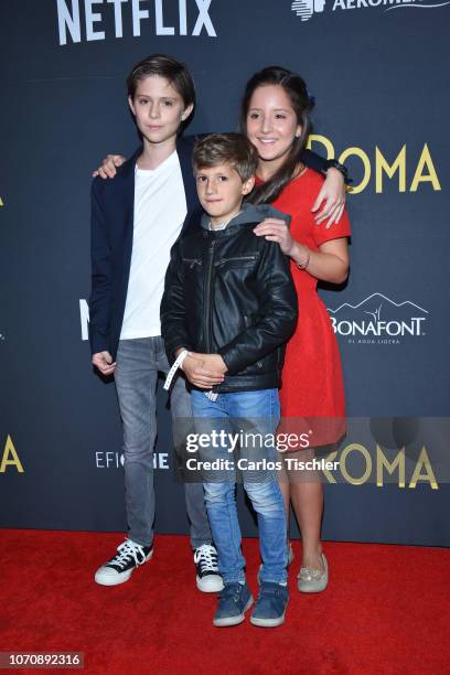 Carlos Peralta, Marco Graf and Daniela Demesa poses for photos during the red carpet and screening of the Alfonso Cuaron and Netflix film 'Roma' at...