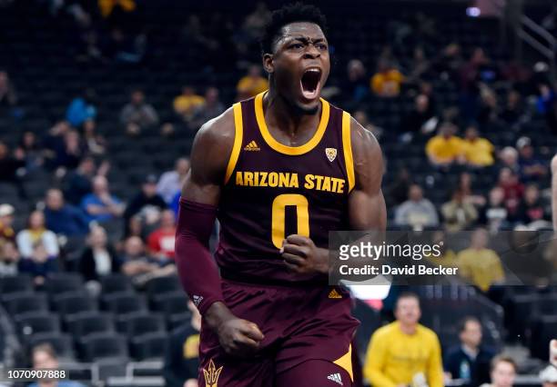 Luguentz Dort of the Arizona State Sun Devils reacts after dunking the ball against the Utah State Aggies during the second half of the championship...