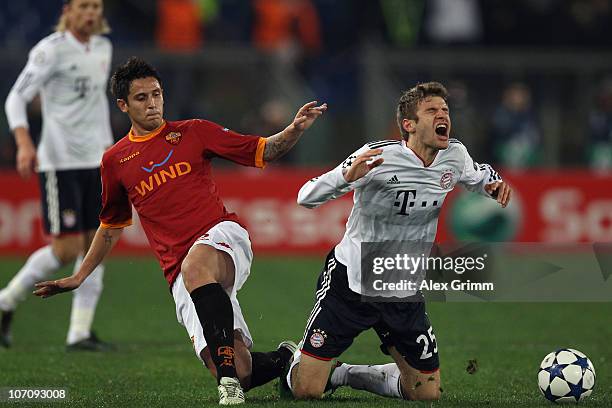 Thomas Mueller of Muenchen is challenged by Nicolas Burdisso of Roma during the UEFA Champions League group E match between AS Roma and FC Bayern...