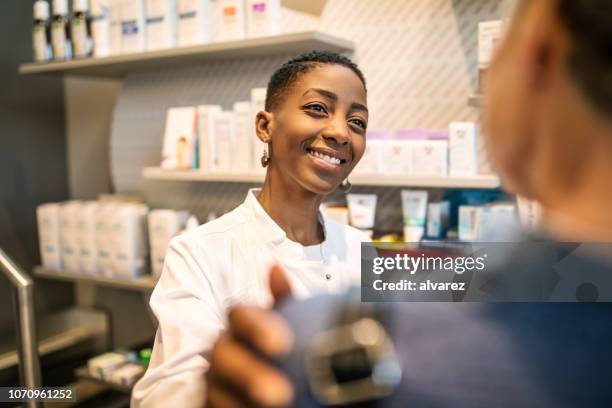 female chemist consoling senior woman - pharmacist and patient stock pictures, royalty-free photos & images