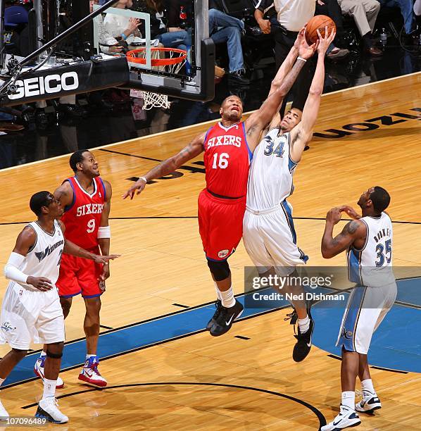 JaVale McGee of the Washington Wizards rebounds against Marreese Speights of the Philadelphia 76ers at the Verizon Center on November 23, 2010 in...
