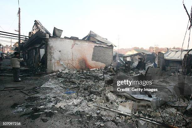 In this image provided by a local resident, Destroyed houses are seen on Yeonpyeong Island, South Korea, following artillery exchange between North...