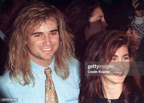 American professional tennis player Andre Agassi with an unknown woman attends a red carpet event, US, March 1990.