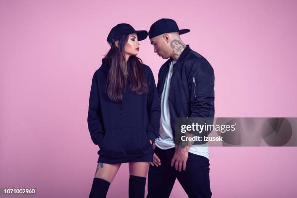 fashion portrait of rebel young couple - male protestor stock pictures, royalty-free photos & images